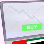 feature image-how to buy stocks in uae -laptop with stock and uae flag